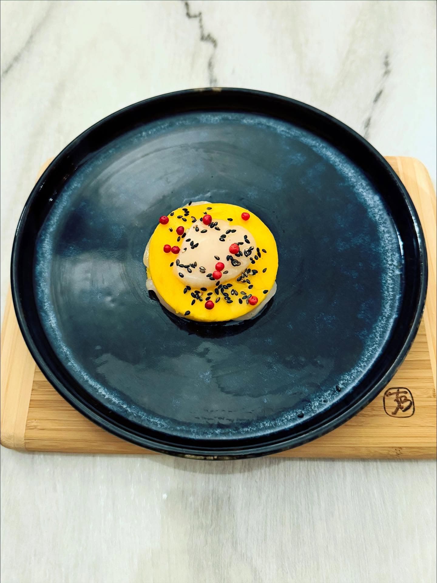 Scallop and mango carpaccio with sesame oil and pink peppercorn