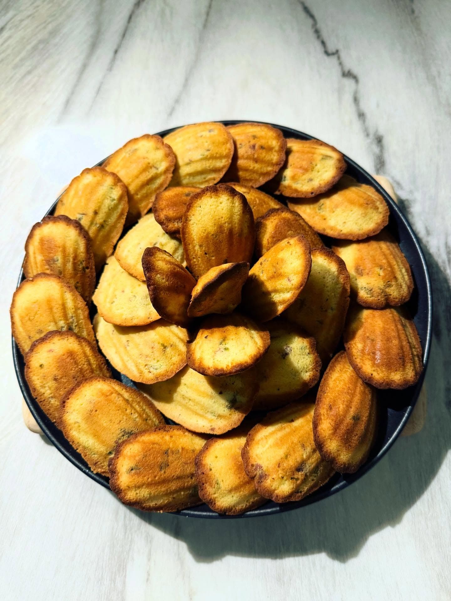 Saffron, pistachio and rose madeleines