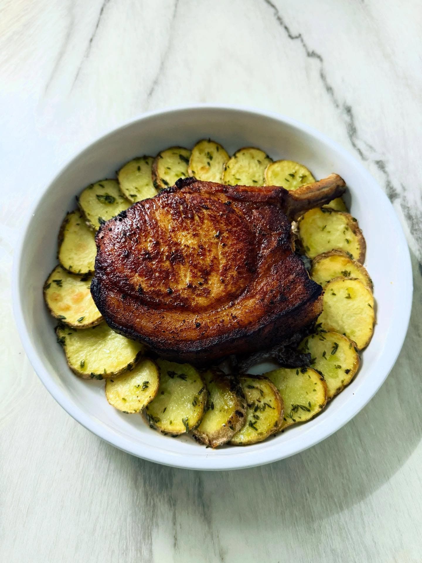 Tandoori pork chop with black trumpet mushroom sauce and roasted potatoes