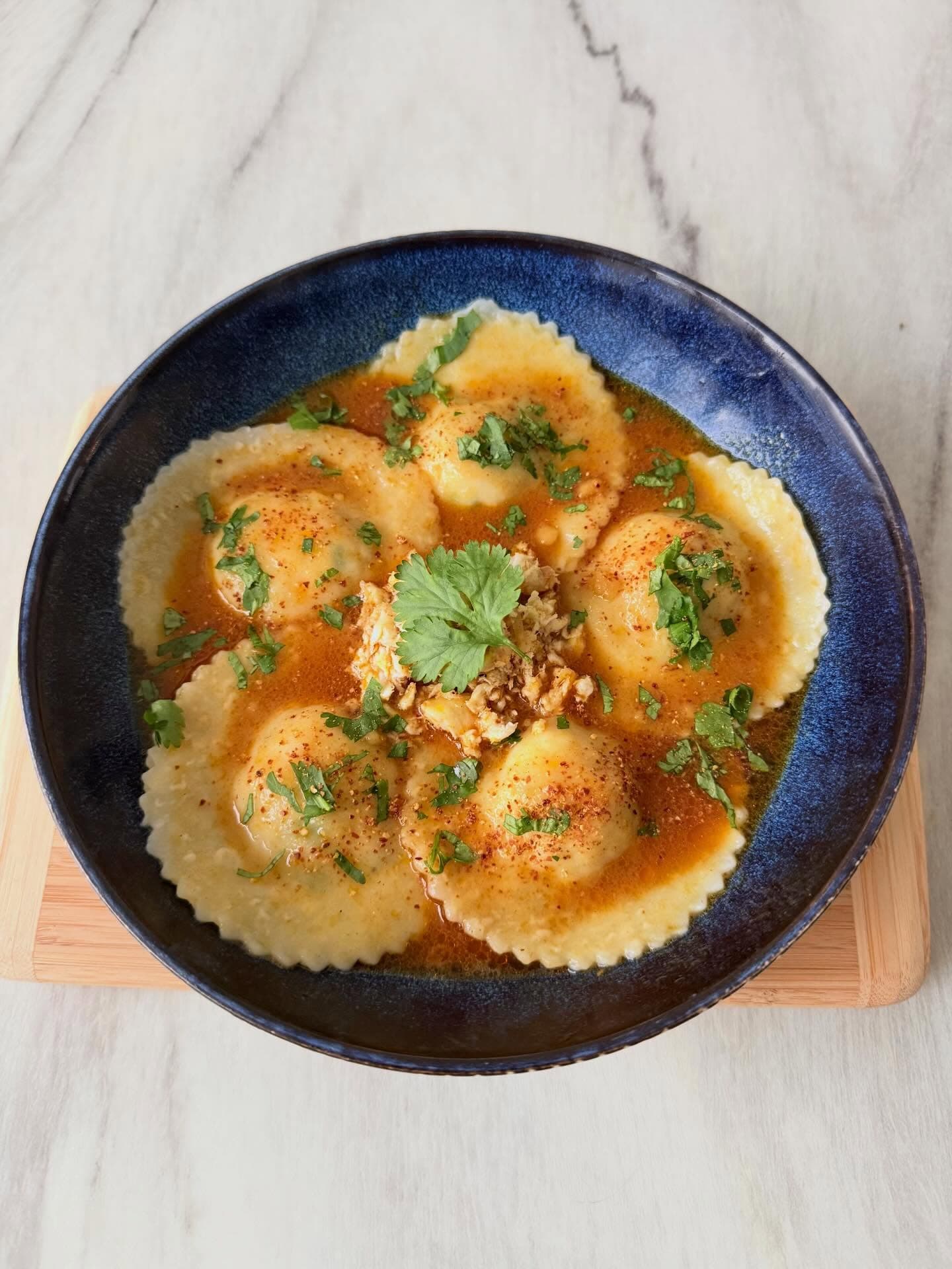 Dorade ravioli in curry sauce with fish stock