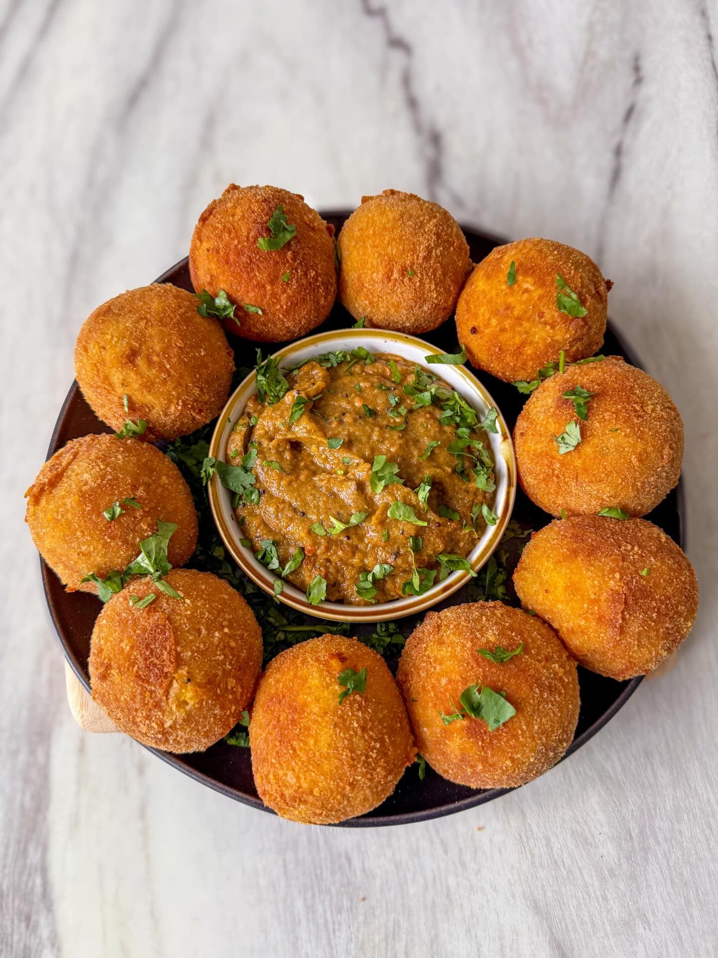 Crispy arancini filled with turmeric dhal and spiced tomato chutney