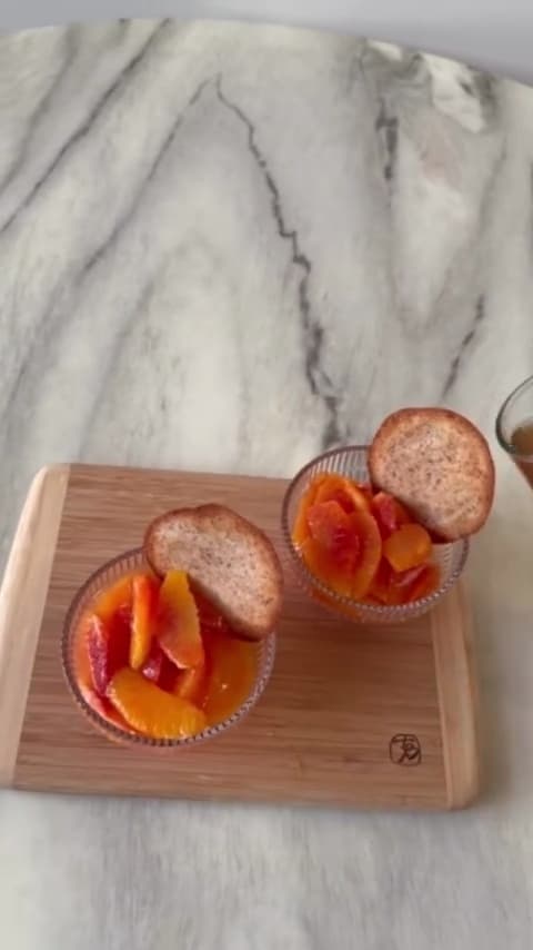 Blood oranges with Indian spiced syrup and almond biscuit