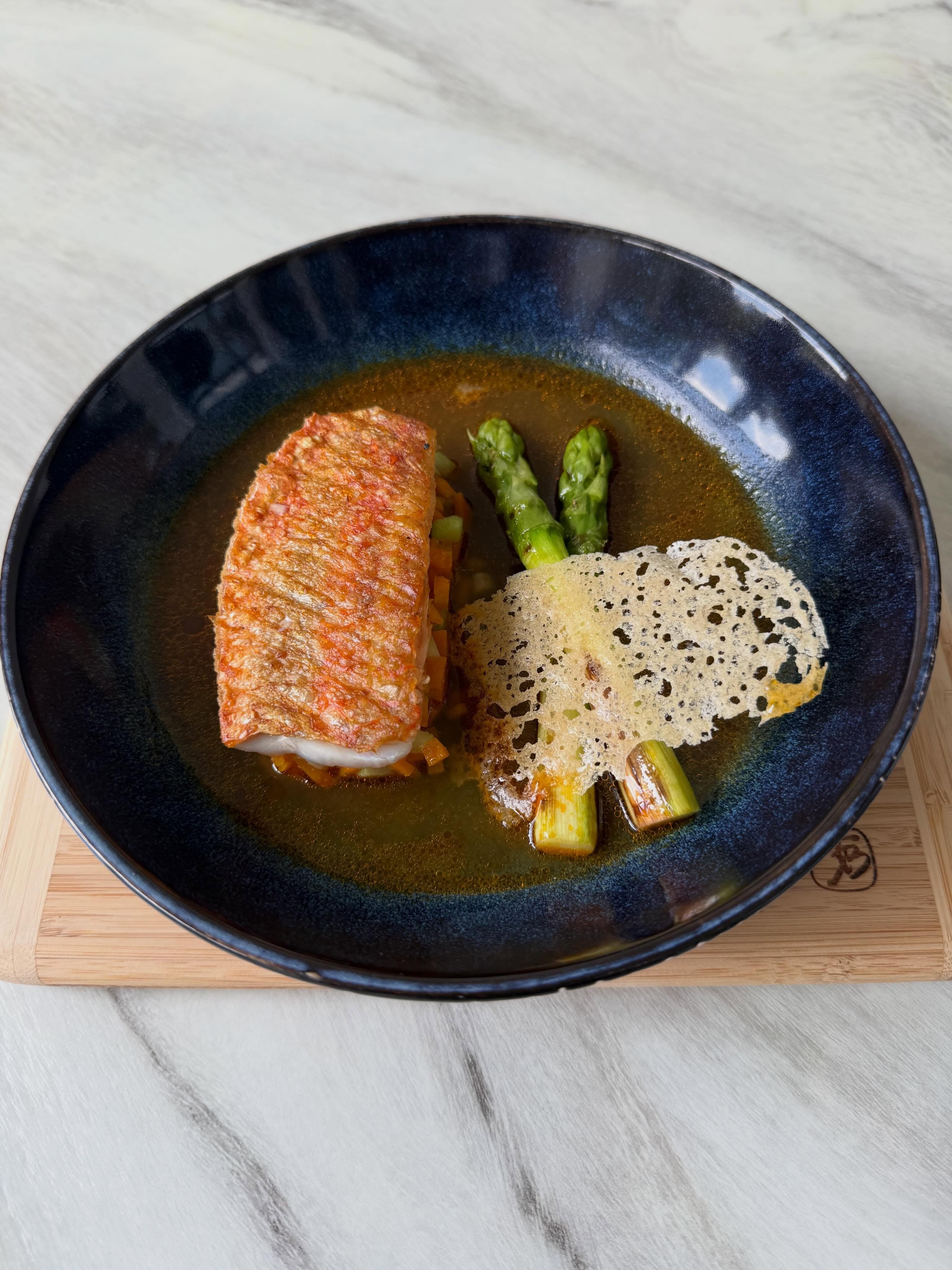 Red mullet with green asparagus, rice tuile and rasam sauce